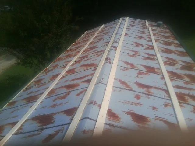 Rusted metal roof panels with new wood purlins before replacement — Storm Damage Roof Repair in Cedar Hill by Roofing Brothers